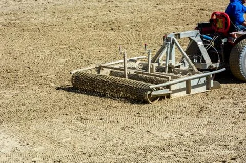 Close up of a tractor preparing the Field before an Equestrian competition in Stock Photos