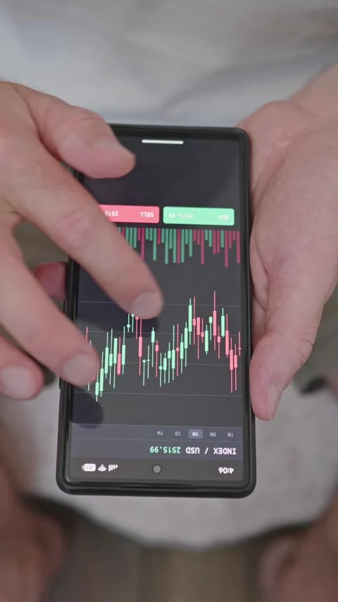 Close up trader hands using trading application on smartphone to check stock Stock Footage 341860658