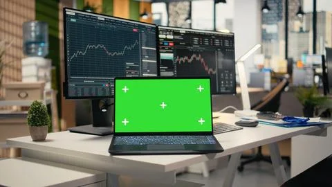 Close up of trading software in forex office with graphs on green screen laptop Foto stock