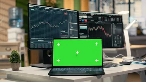 Close up of trading software in forex office with graphs on green screen laptop Foto stock