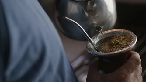 Close up of traditional Argentine mate being served with hot water in a gourd. Stock Footage 331463561