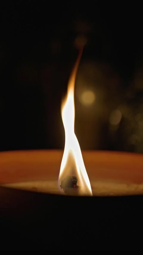 Close-up of a traditional candle burning on a grave. Stock Footage 345761709