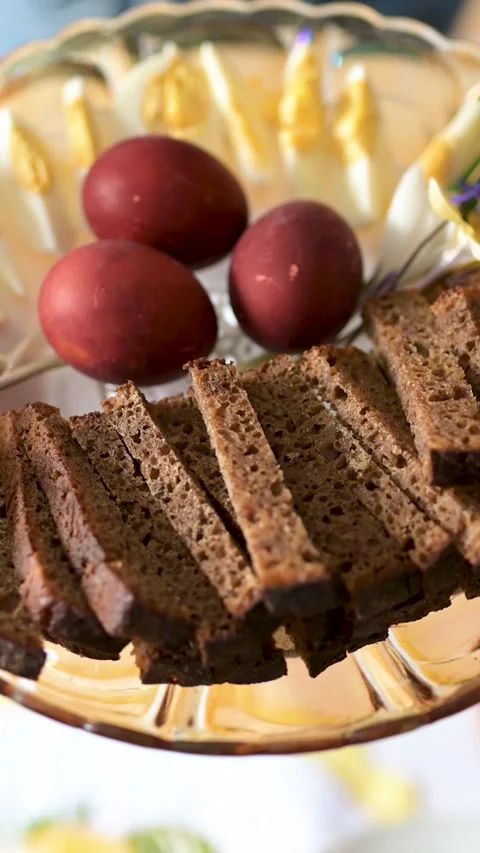 Close-up of traditional Easter plate full of coloured eggs and bread slices. Stock-Footage 305124302