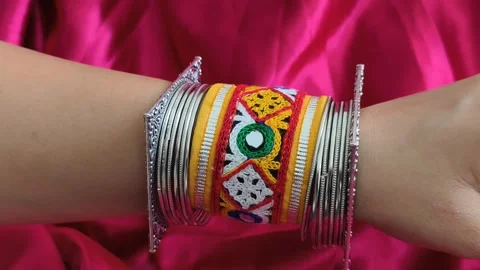 Close-up of traditional embroidered bracelet with mirror work paired with oxidiz Stock Footage 310604331