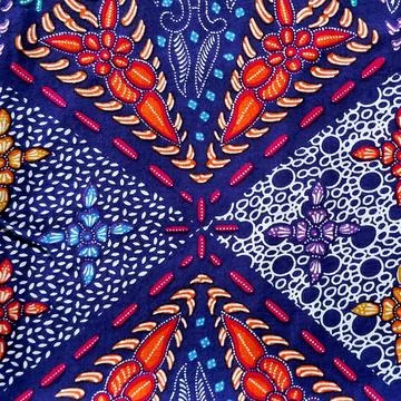 Close-up of traditional Javanese Batik pattern on dark indigo blue fabric. Stock Photos
