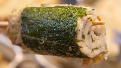 Close Up of Traditional Korean Fish Cake Skewer with Perilla Leaf Stock Footage 337375025