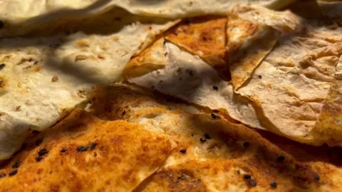 Close-Up of Traditional Middle Eastern Thin Flatbread in Dappled Sunlight Stock Footage 345321796