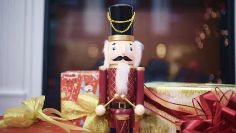 Close up of a traditional nutcracker Christmas figurine surrounded by wrapped Stock Footage 329390304