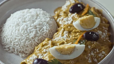 Close-Up of Traditional Peruvian Ají de Gallina with White Rice Stock Footage 339077898