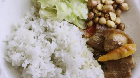 Close Up of Traditional Rice Dish Served with Braised Pork Cabbage and Peanuts Stock-Footage 341533744