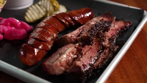 Close-Up of Traditional Texas Two Meat BBQ Plate with Brisket and Sausage Stock Footage 346249413