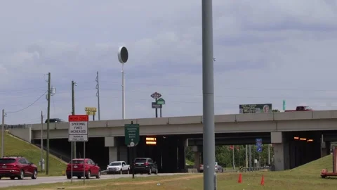 Close up Traffic on a bridge and underpass with restaurant signs urban scener Stock Footage 153571142
