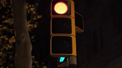 Close-up of a traffic light at night with the yellow light flashing while red Stock Footage 315655784