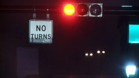 Close up of traffic light with "No Turns" signage, night. 스톡 동영상 107993731