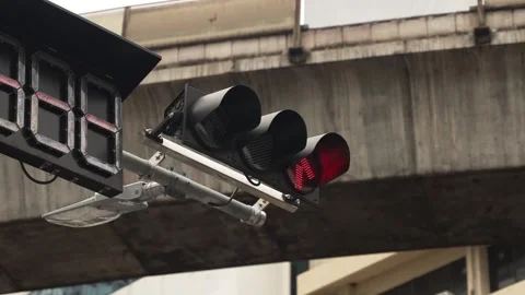 Close-up of a traffic light with a red arrow over crossroad in the city against Video stock 288952355