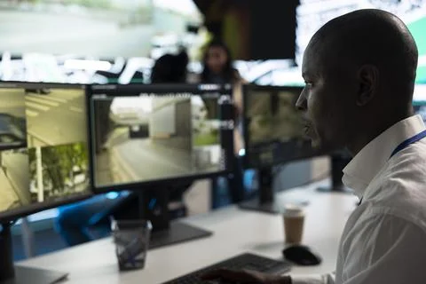 Close up of traffic operator studying road camera feeds Stock Photos