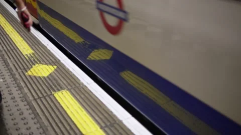 Close up of train arriving at platform in London Underground tube station Stock Footage 233848380