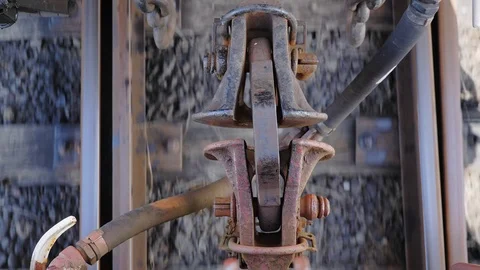Close up of train carriage coupling hook connection between cars while moving Stock Footage 102332614
