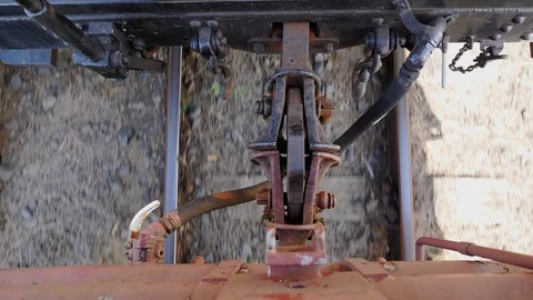 Close up of train carriage coupling hook connection between cars while moving Stock Footage 102333182
