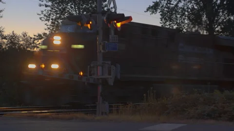Close Train Crossing at Sunrise 4K Stock Footage 160144345