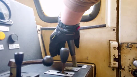 Close-up of a train driver's hand operating controls in the cabin during a Stock Footage 266127984