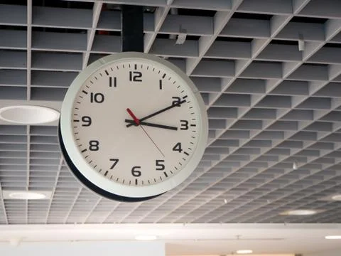 Close-up of train station clock hanging from the ceiling. Stock Photos