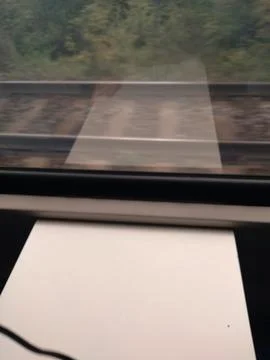Close-up of train tracks and a train window Stock Photos