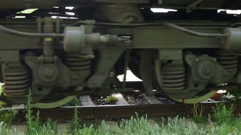 Close up of train wheels and wagons of an ore train pass by the camera. Stock Footage 131252878