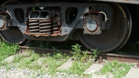 Close up of train wheels and wagons of an ore train pass by the camera. Stock Footage 131253064