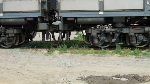 Close up of train wheels and wagons of an ore train pass by the camera. Stock Footage 131403136