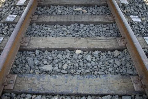 Close up of train wheels on railway tracks and wooden sleepers Stock Photos