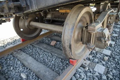 Close up of train wheels on railway tracks and wooden sleepers Stock Photos