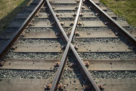 Close up of train wheels on railway tracks and wooden sleepers. Stock Photos