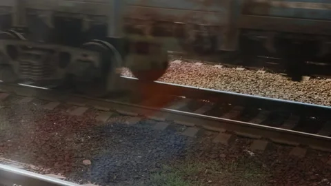 Close-up of train wheels on tracks in rapid motion. Industrial view of a passing Stock Footage 318907395