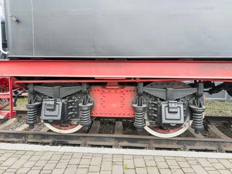 Close-up of train wheelset with red underframe, intricate mechanical compon.. Stock Photos