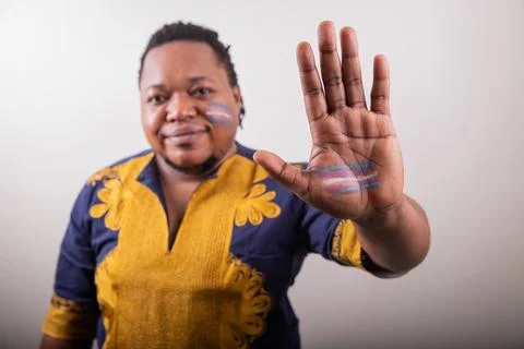 Close up of the trans flag drawn on the hand of an african trans person. St.. Stock Photos