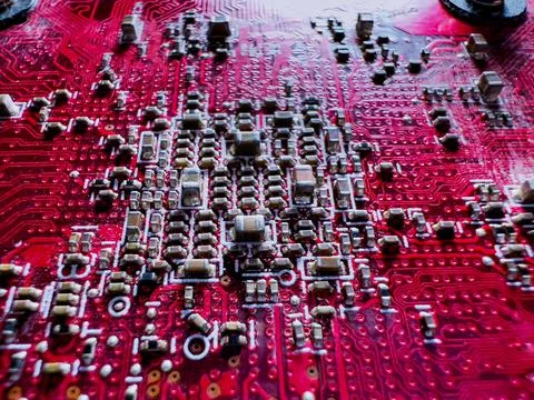 Close-up of transistors and chips on the red circuit board Stock Photos