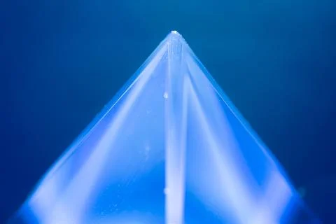 Close up of a translucent blue pyramid Stock Illustration