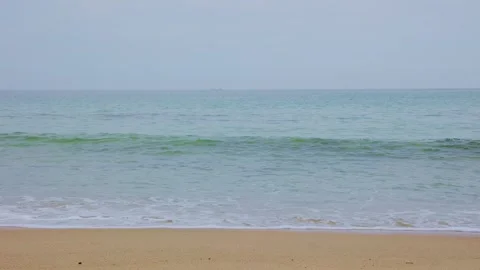 Close-up of translucent emerald green sea waves on sandy shore Stock Footage 338194029