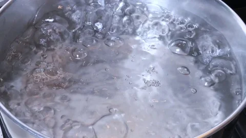 Close up of transparent and limpid water boiling in a silver pot. Stock-Footage 84655266