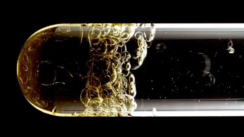 Close up transparent gold Air Bubbles, in up in Glass Test Tube on Black Stock-Footage 275987148