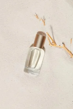 Close-up of transparent perfume bottle without label standing out against w.. Stock Photos