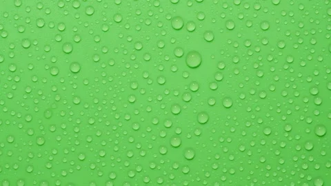 Close-up transparent water drops texture rotating on green chroma key background Stock Footage 195078989