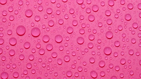 Close-up transparent water drops texture rotating on pink abstract background Stock Footage 195148053