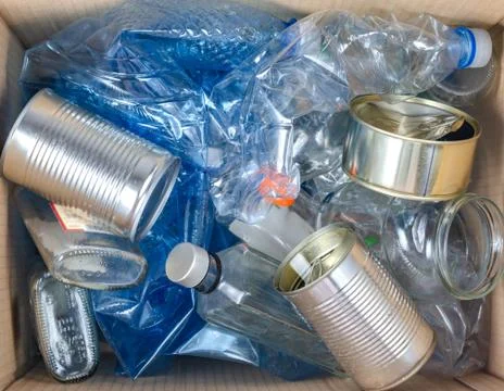 Close up of trash bin full with plastic , glass  bottles and   steel  cans . Stock Photos