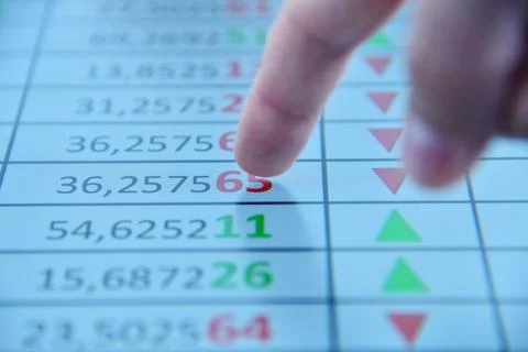 Close up of trater man finger points to stock numbers Stock Photos