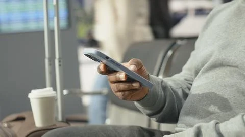 Close up of traveler using smartphone app in bus station Stock Photos