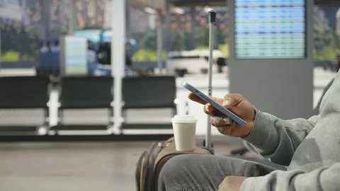 Close up of traveler using smartphone app in bus station Stock Photos