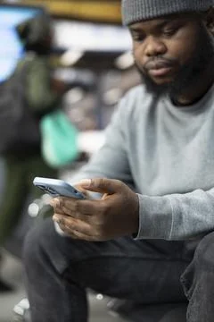 Close up of traveler using smartphone in bus station, planning route itinerary Stock Photos