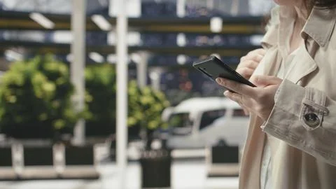 Close up of traveler using smartphone device in bus station Stock Photos
